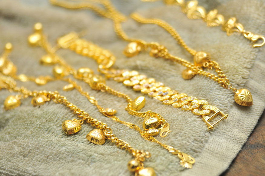 strands of gold necklaces drying
