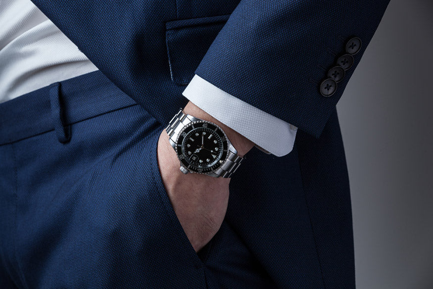 Hand in pocket with wrist watch in a business suit